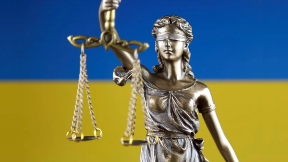 Статуя Феміди на тлі прапора України як символ судової реформи